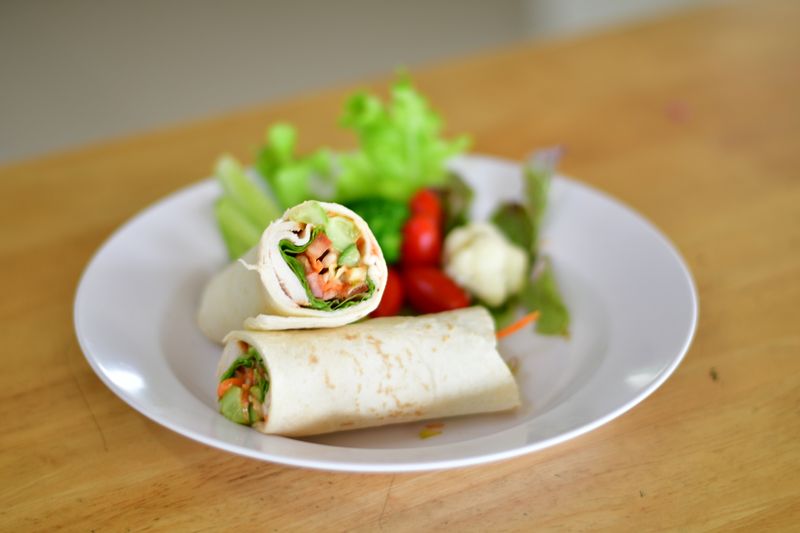 Veggie hummus wrap with roasted red peppers and spinach